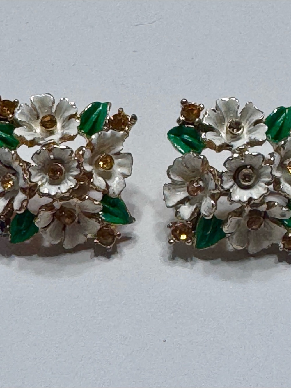 White Floral Cluster Clip-On Earrings with Green Leaves and Gold Accents